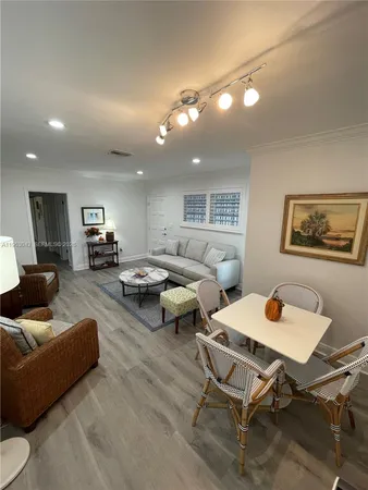 a living room with lots of furniture and a wooden floor