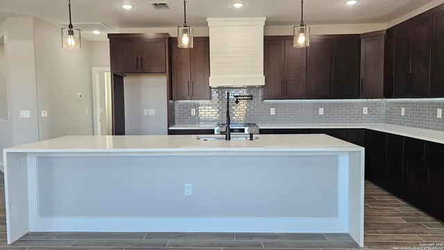 a bathroom with a sink a large mirror and a shower