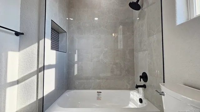 a bathroom with a tub and a shower