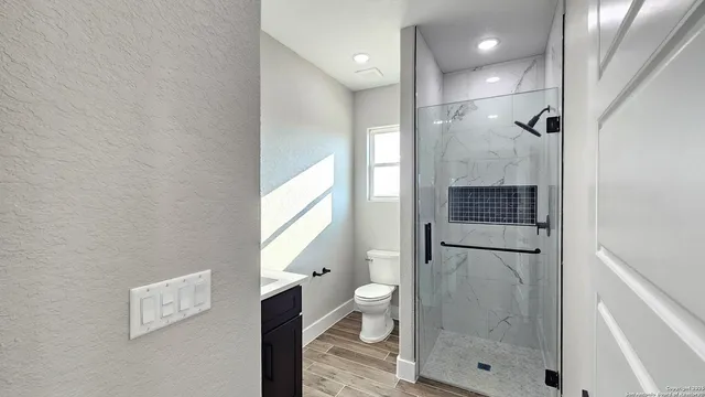 a bathroom with a shower and toilet
