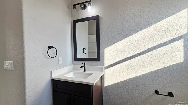 a bathroom with a sink and a mirror