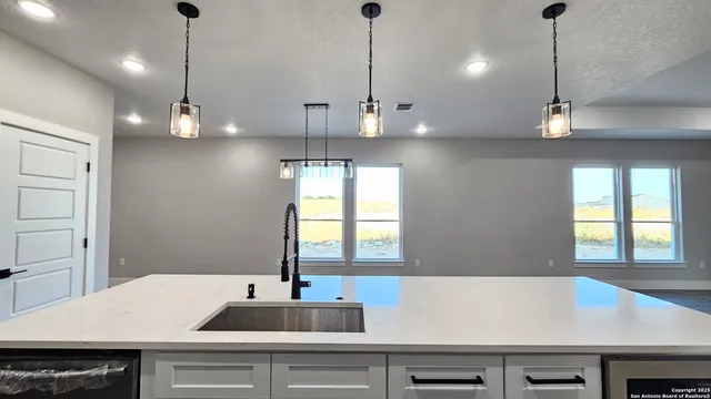 a view of a kitchen with a sink and window