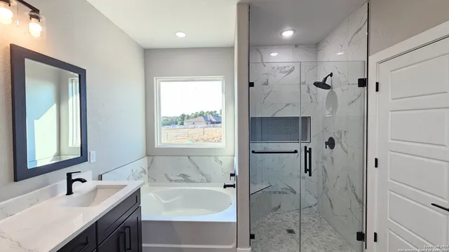 a bathroom with a double vanity sink mirror and shower