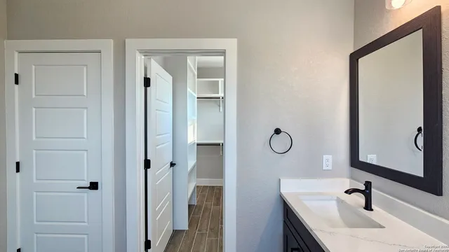 a bathroom with a sink and mirror