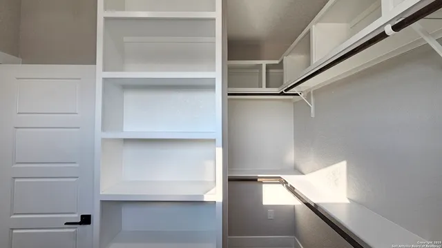 a view of an empty walk in closet