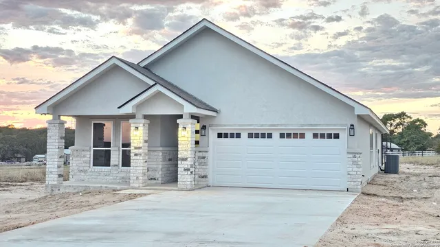 a view of a house with a wooden fence