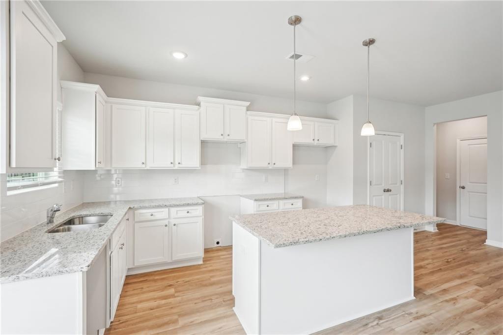 3002 Viewpark Circle Conyers, GA 30013 - Photo 11 of 41 a kitchen with kitchen island a sink stainless steel appliances and cabinets