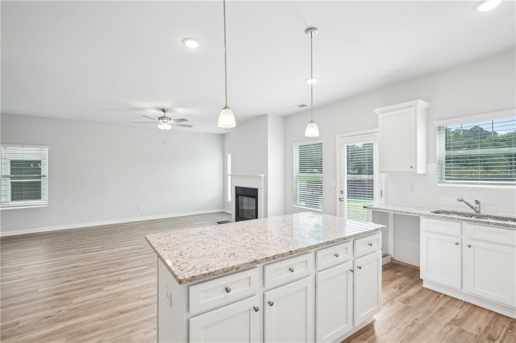 3002 Viewpark Circle Conyers, GA 30013 - Photo 15 of 41 a kitchen with a sink chandelier and wooden floor