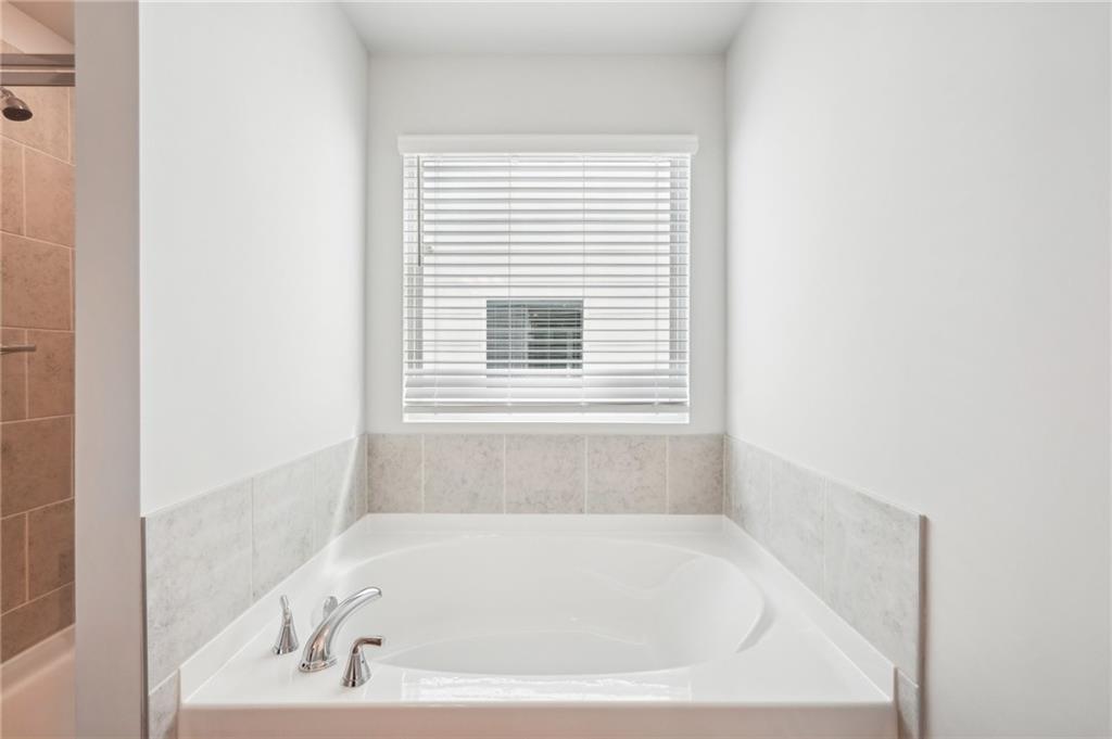 3002 Viewpark Circle Conyers, GA 30013 - Photo 37 of 41 a white bath tub sitting in a bathroom