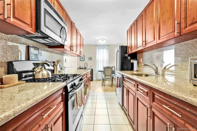 a kitchen with stainless steel appliances granite countertop a sink and cabinets