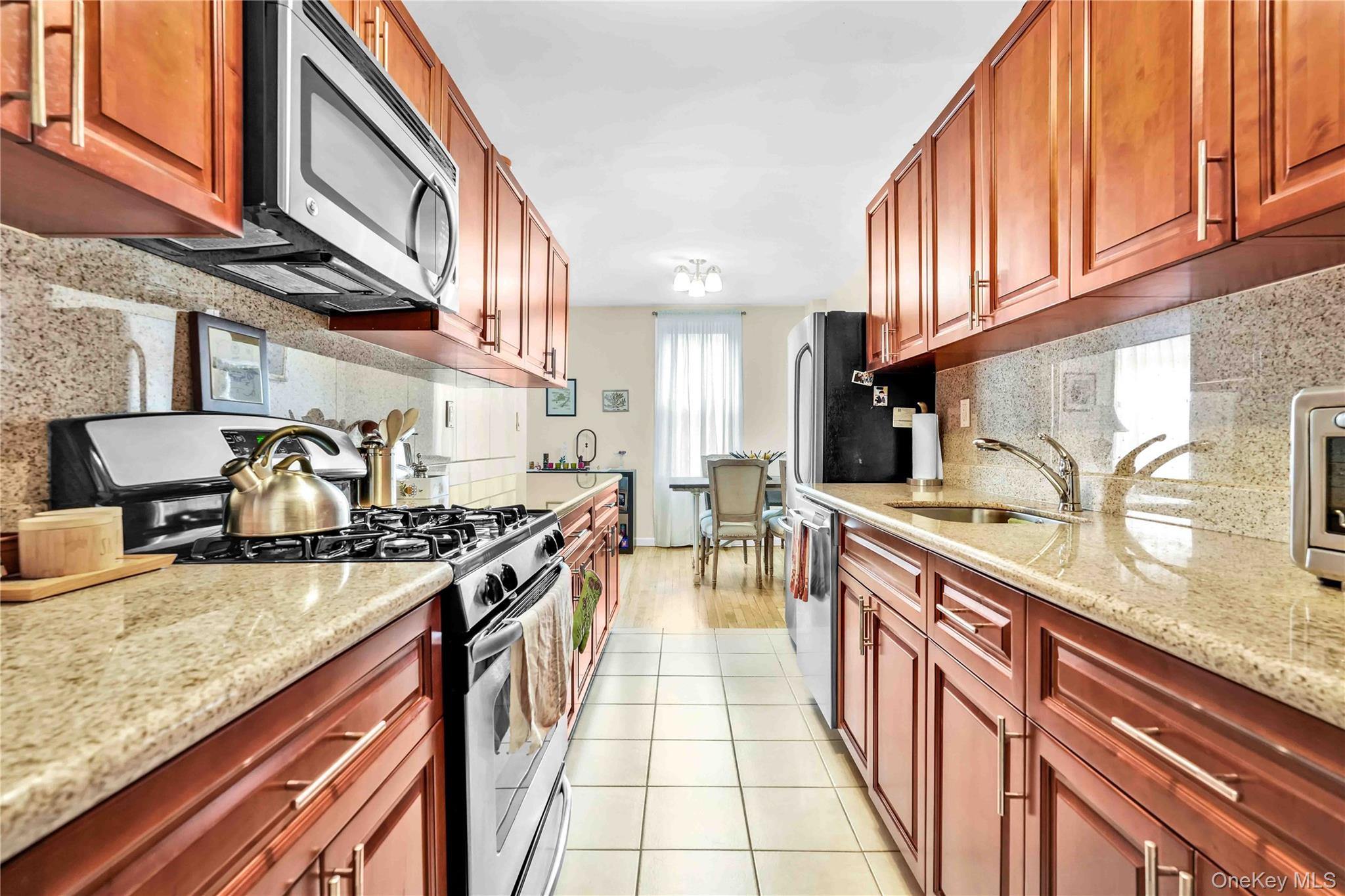 a kitchen with stainless steel appliances granite countertop a sink and cabinets