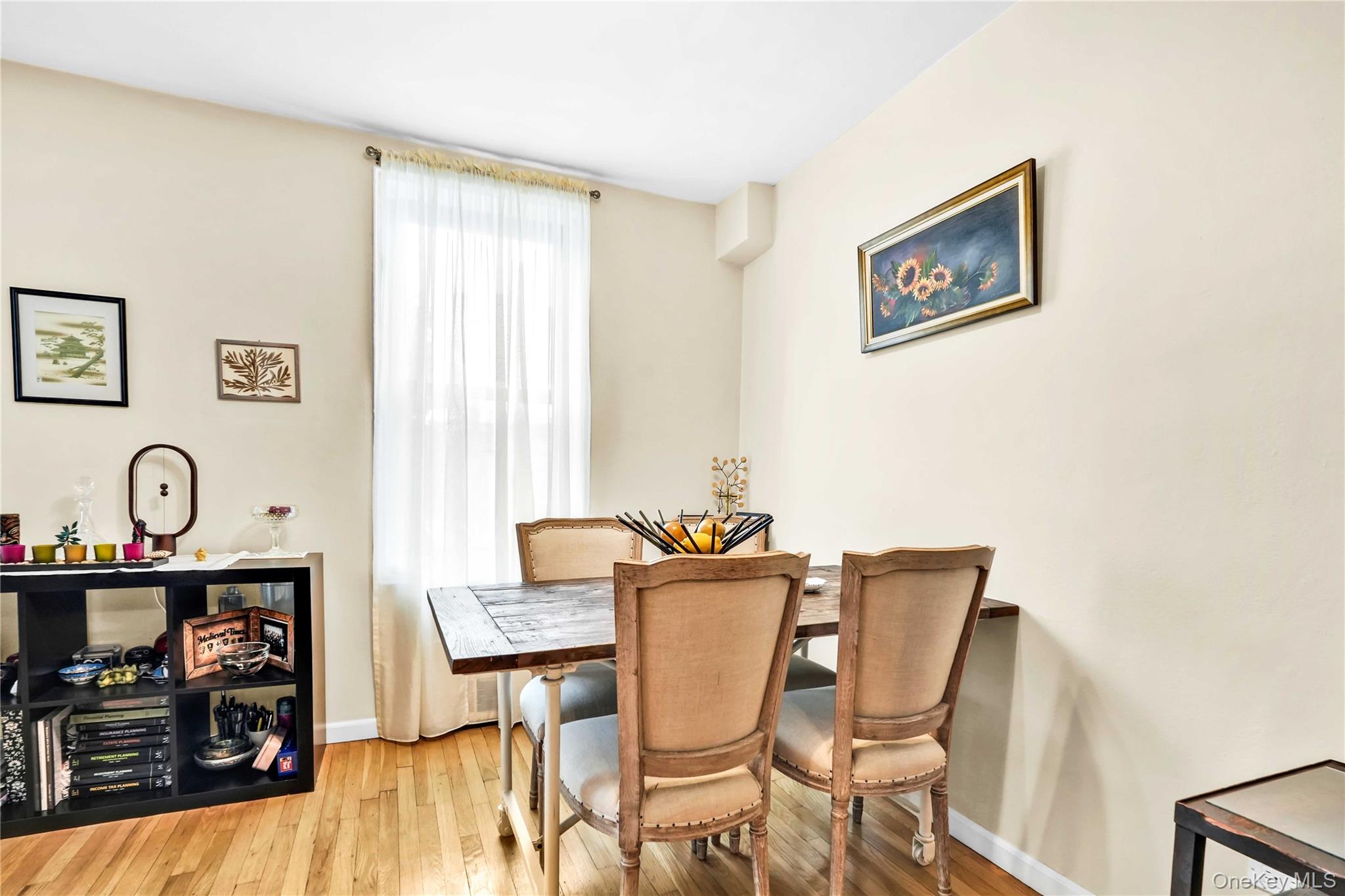 209-10 41st Avenue, Unit 2J Queens, NY 11361 - Photo 11 of 35 a view of a dining room with furniture and wooden floor