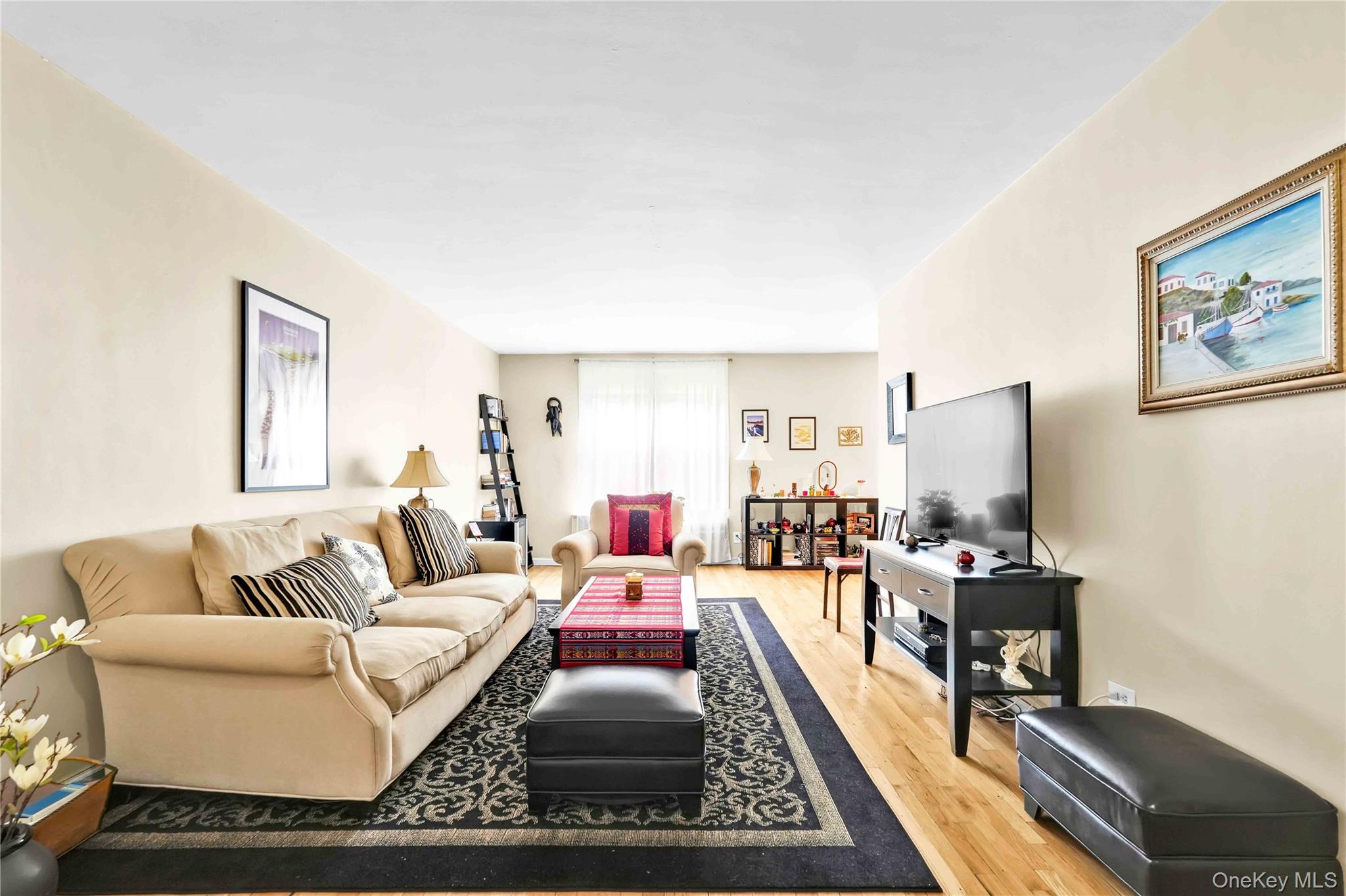 209-10 41st Avenue, Unit 2J Queens, NY 11361 - Photo 15 of 35 a living room with furniture and a flat screen tv