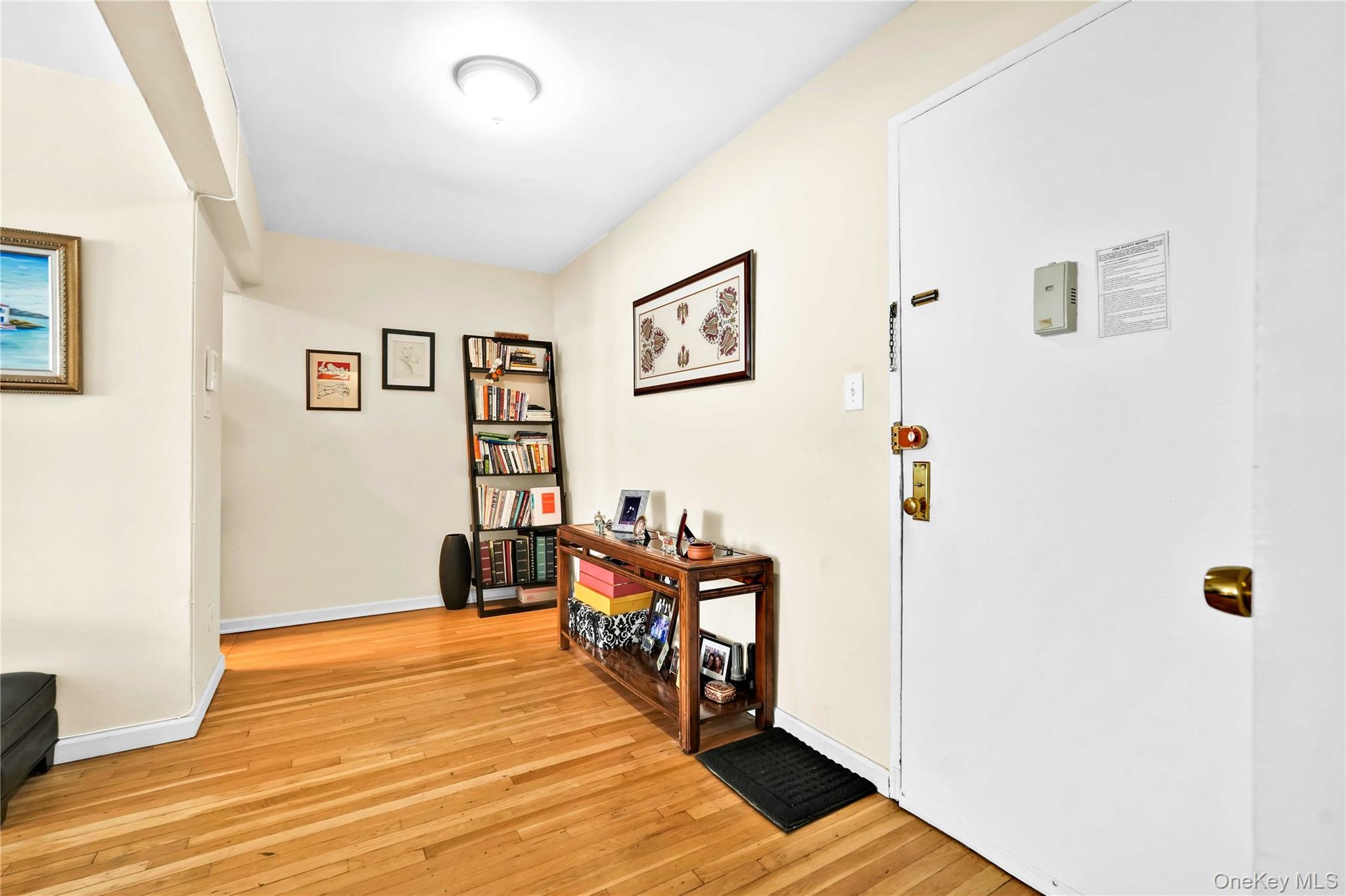 209-10 41st Avenue, Unit 2J Queens, NY 11361 - Photo 17 of 35 a bed room with a bed and a chair