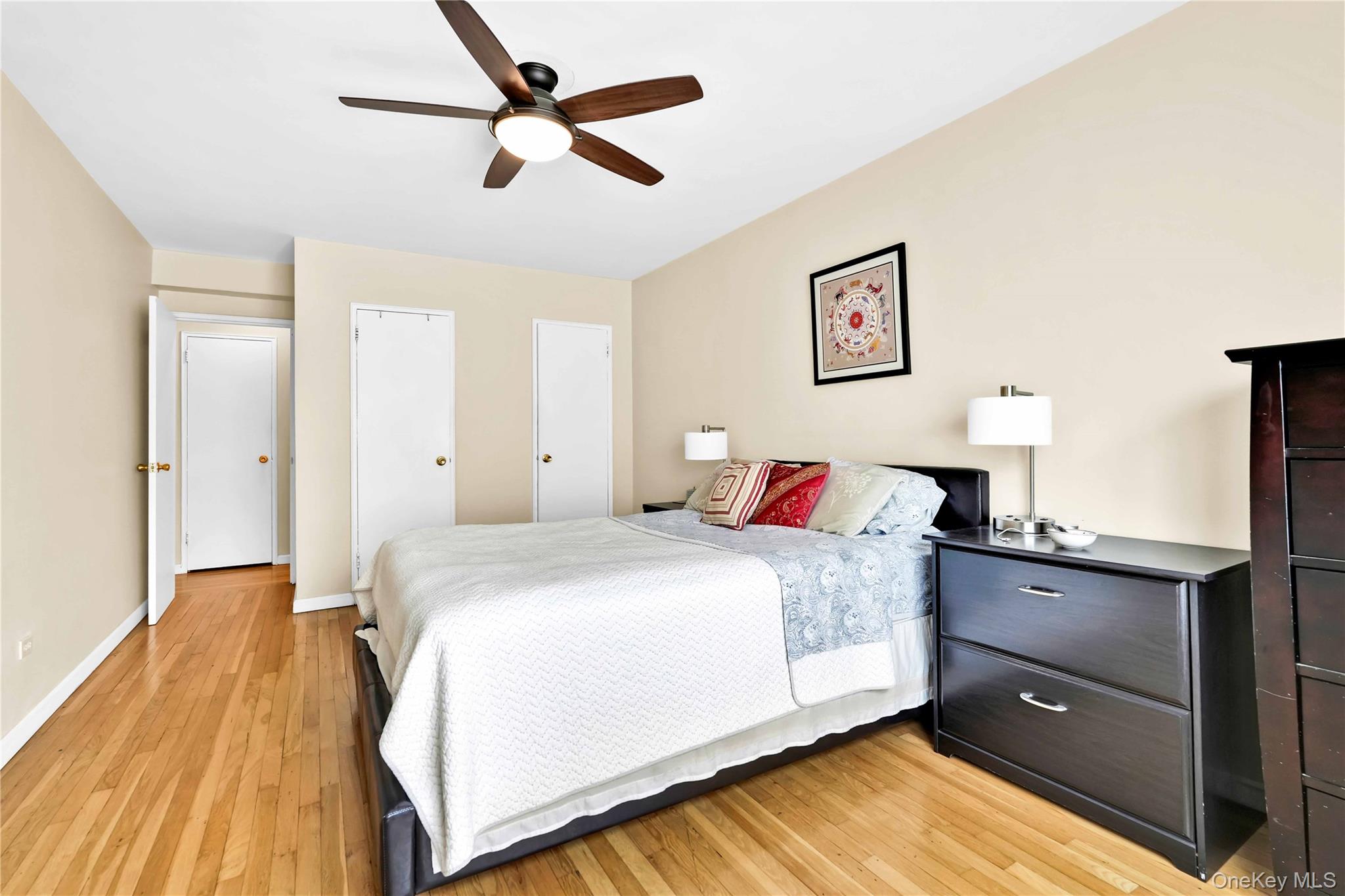 209-10 41st Avenue, Unit 2J Queens, NY 11361 - Photo 21 of 35 a bedroom with a bed and a chandelier