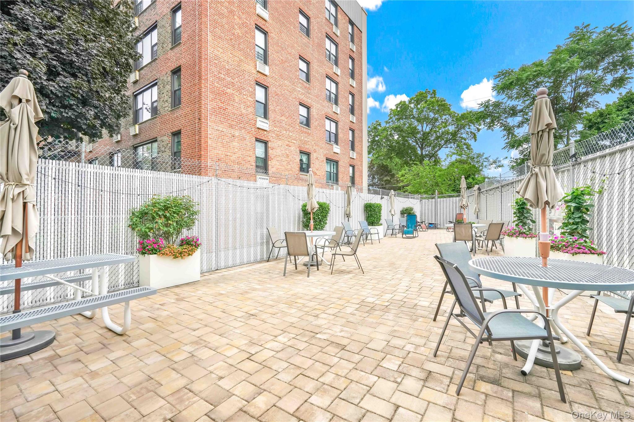 209-10 41st Avenue, Unit 2J Queens, NY 11361 - Photo 32 of 35 a view of backyard with a table and chairs