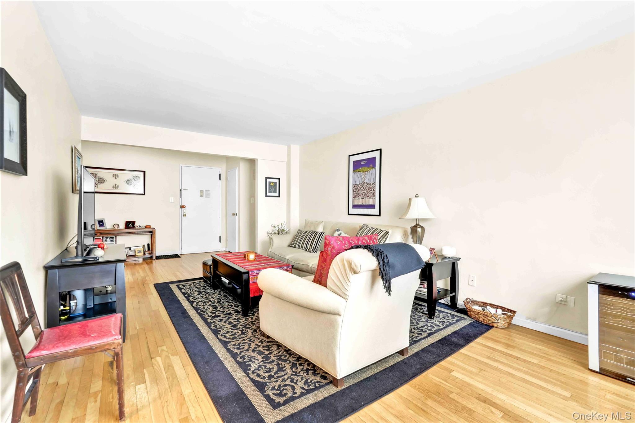 209-10 41st Avenue, Unit 2J Queens, NY 11361 - Photo 8 of 35 a living room with furniture and wooden floor