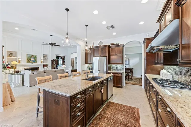 a kitchen with stainless steel appliances granite countertop a stove a sink dishwasher and a refrigerator