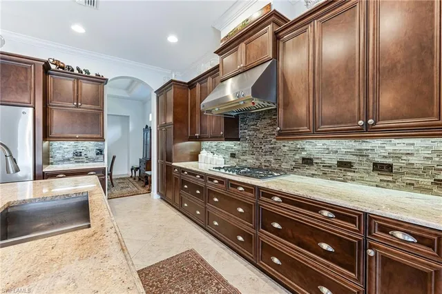 a kitchen with stainless steel appliances granite countertop a sink and cabinets