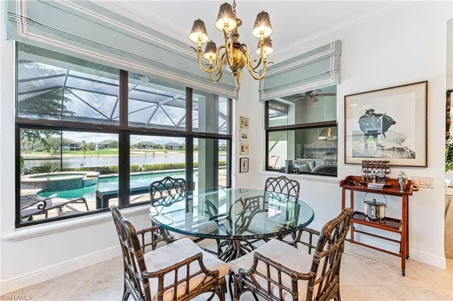 a dining room with furniture a painting and a chandelier
