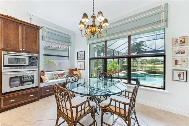 a dining room with furniture a chandelier and wooden floor