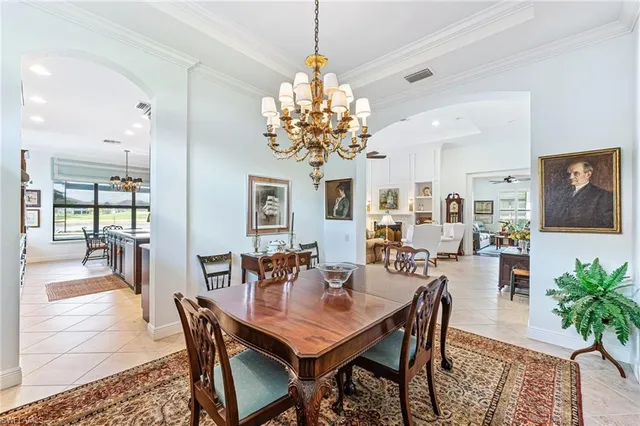 a dining room with furniture a chandelier and wooden floor
