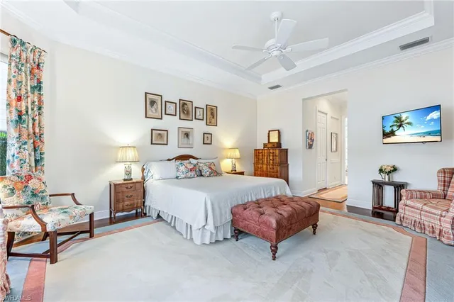 a spacious bedroom with a bed and a couch