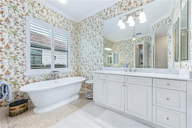 a spacious bathroom with double vanity and a bathtub
