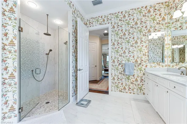 a bathroom with a double vanity sink mirror and shower