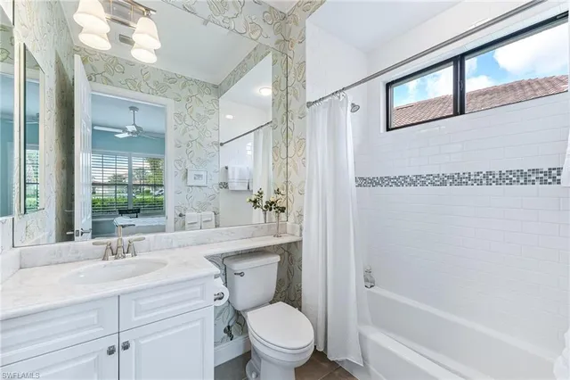 a bathroom with a sink toilet a mirror and shower