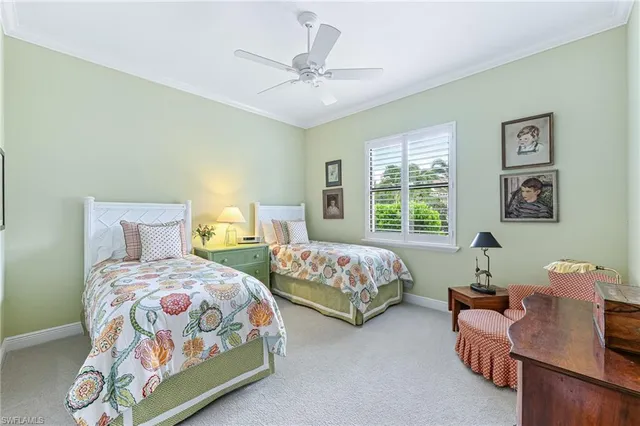 a bedroom with two beds and a window