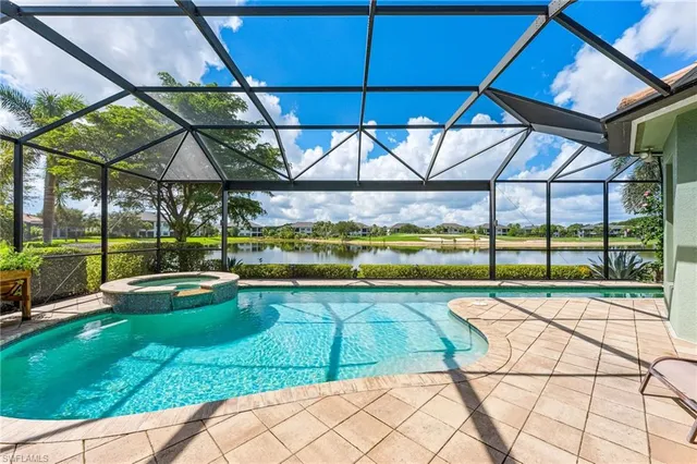 a view of backyard with swimming pool and outdoor seating