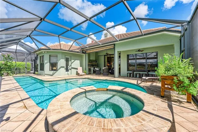 a swimming pool with outdoor seating and yard