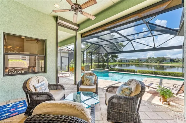 a living room with patio furniture and a floor to ceiling window