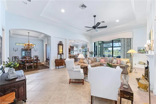 a living room with patio furniture and a chandelier