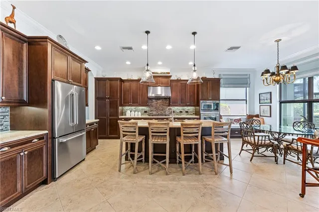 a large kitchen with a table and chairs