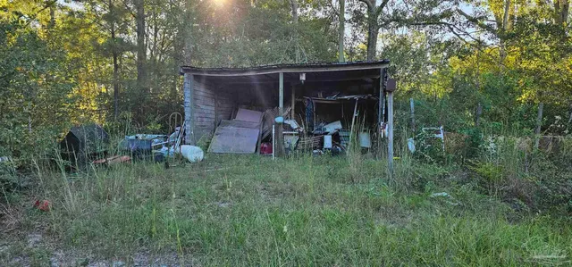 a view of a chair and table in a backyard of the house