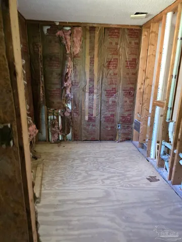 a view of walk in closet with clothes