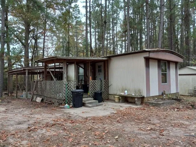 a view of a wooden fence with a yard