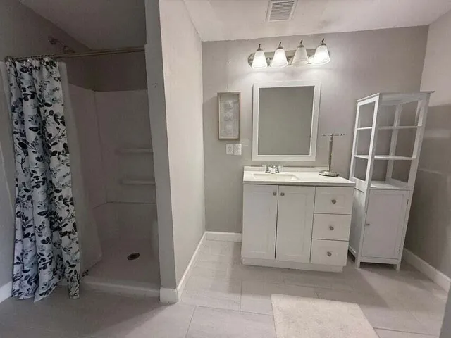 a bathroom with a double vanity sink and mirror