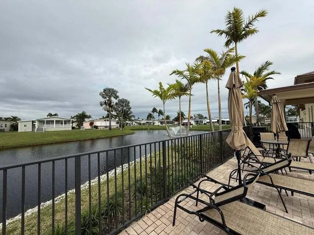 a view of a lake with a table and chairs