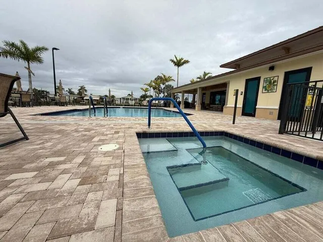a view of swimming pool with a lounge chairs