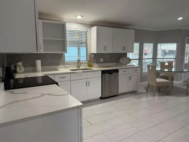 a kitchen that has a sink and a stove in it