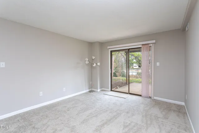 an empty room with sliding glass door