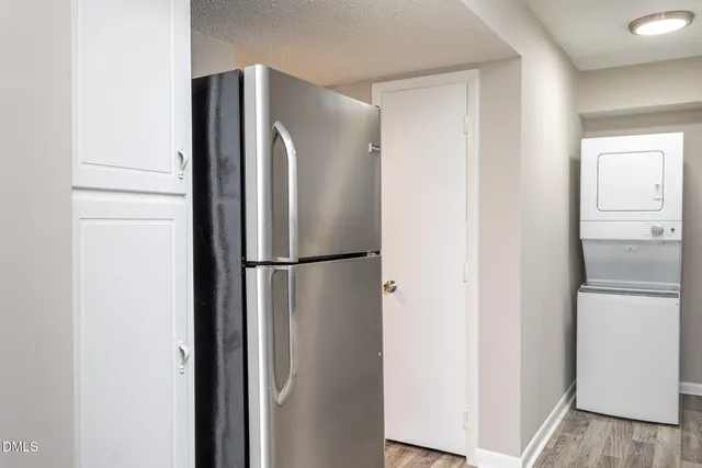 a metallic refrigerator freezer sitting in a kitchen