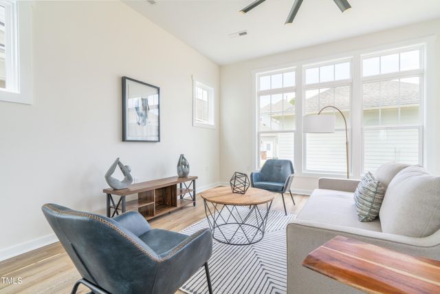 a kitchen with stainless steel appliances granite countertop a sink a stove a refrigerator and island with wooden floor