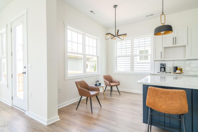 a large kitchen with stainless steel appliances granite countertop a lot of cabinets and wooden floor