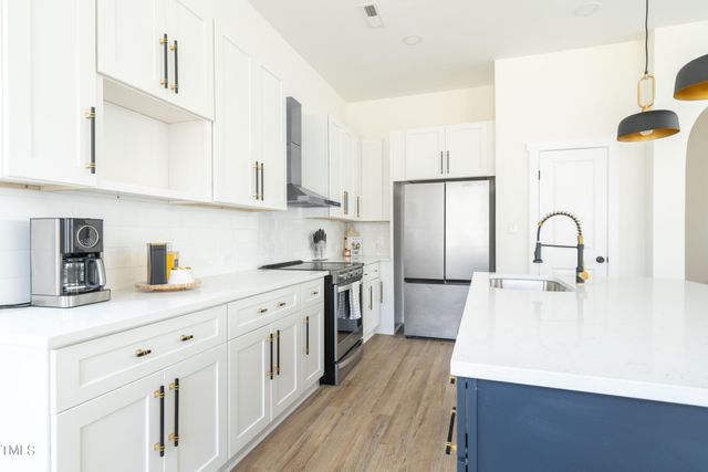 a kitchen with a sink and a refrigerator