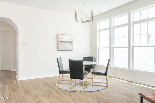 a large kitchen with a table and chairs