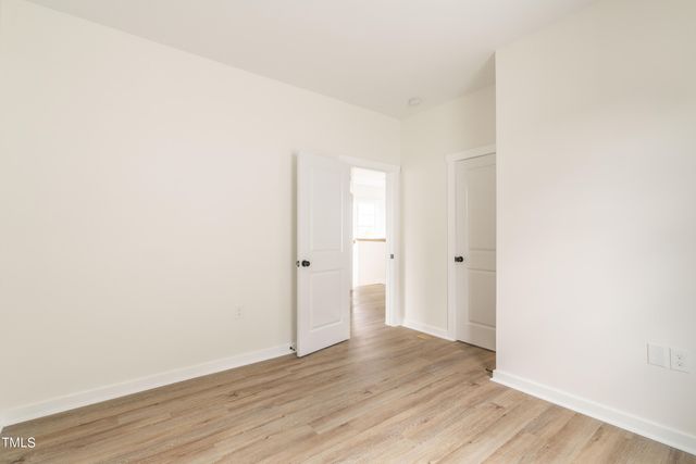 a bed room with a bed and a night stand